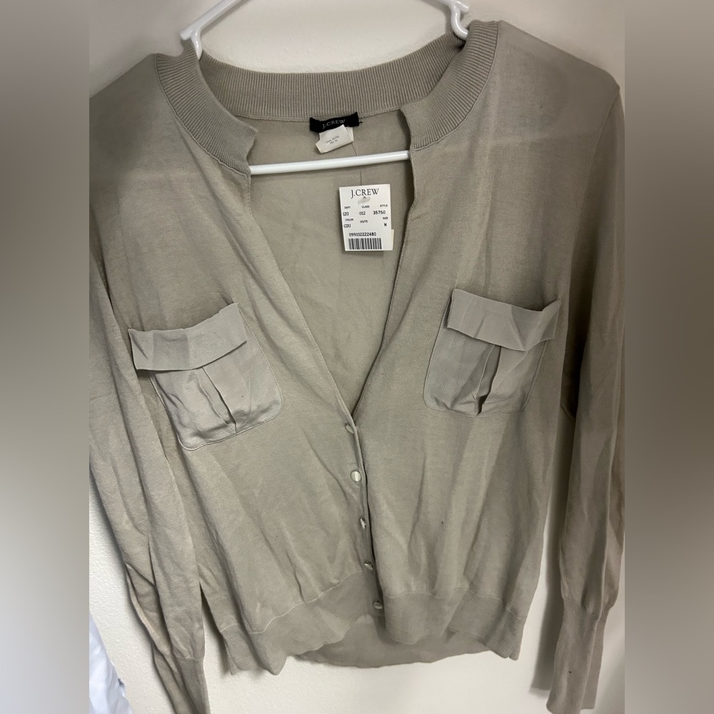 New with tag sweater top with pockets and long sleeve.